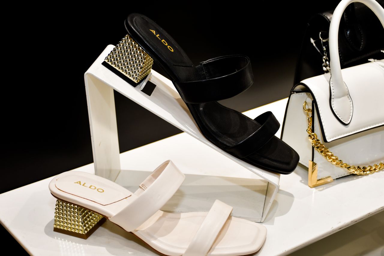 heros-img Elegant display of Aldo sandals and bag featuring modern fashion design.